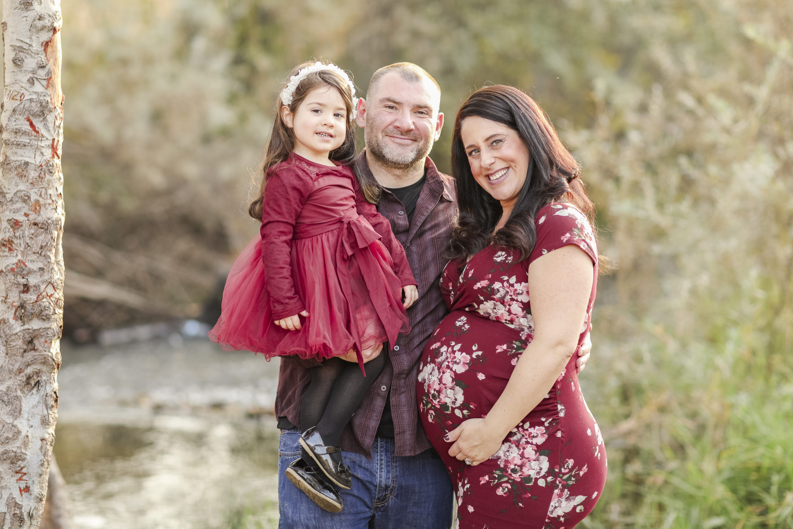 family posing for maternity portraits
