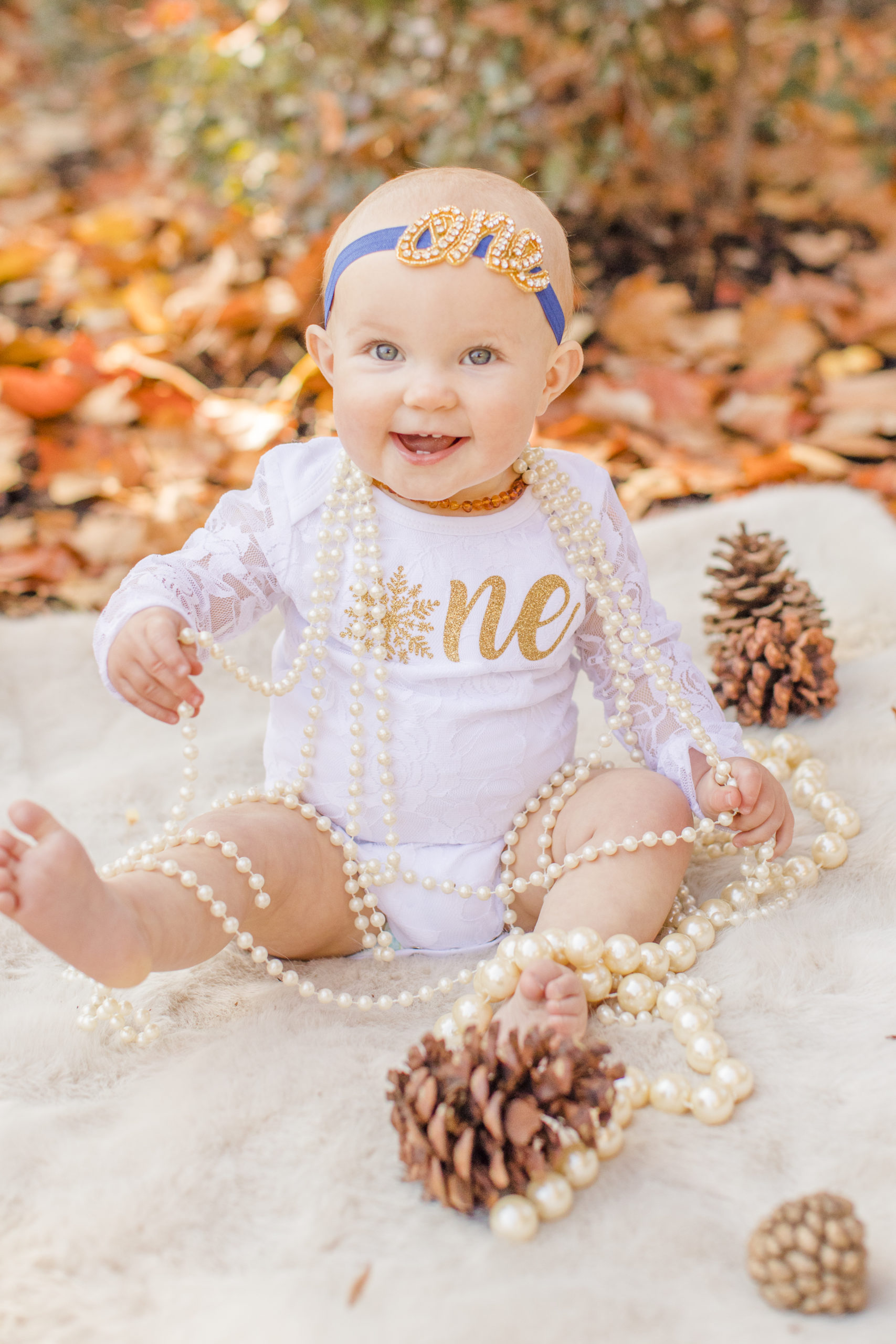 first year baby girl wearing pearls