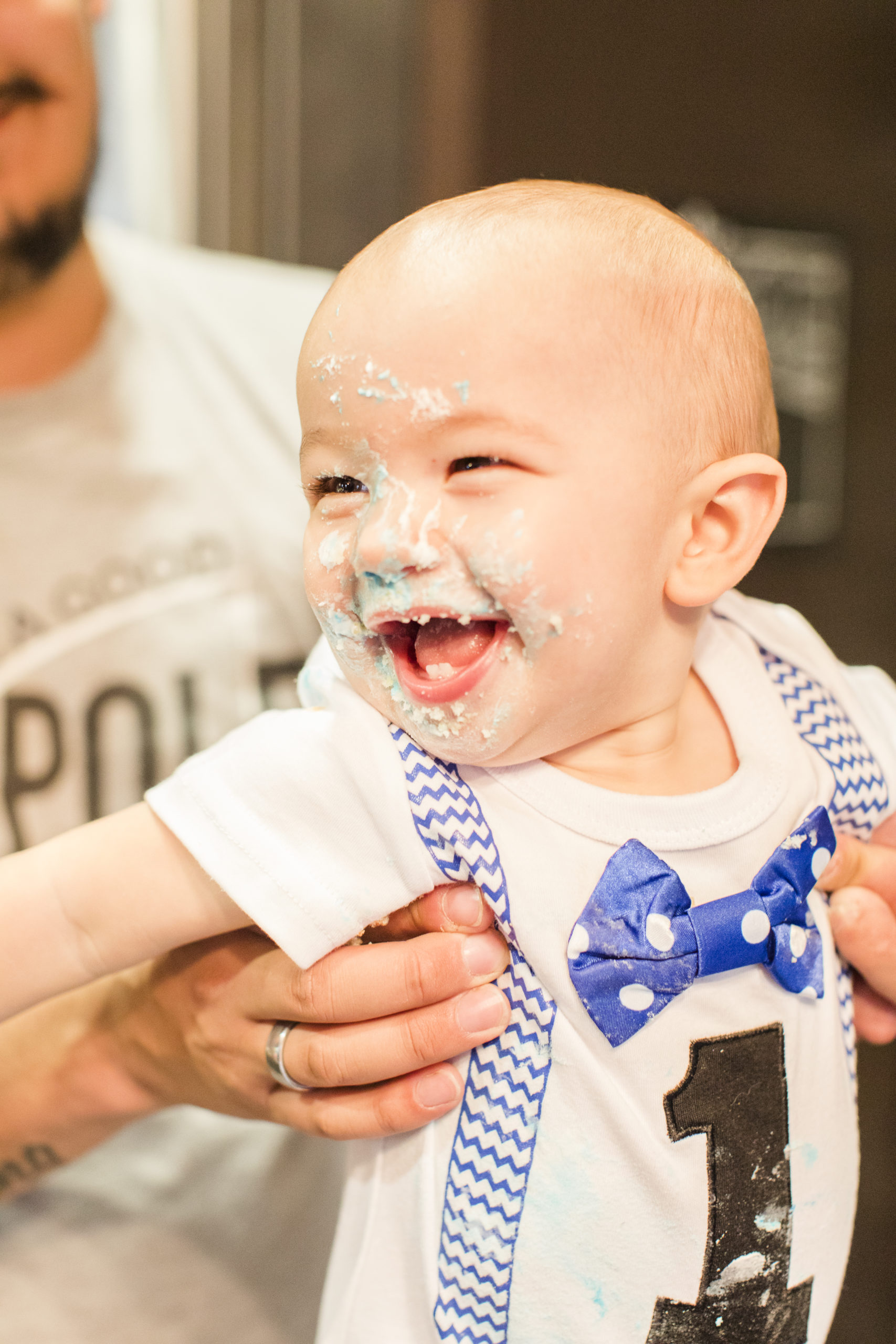one year baby with cake on face