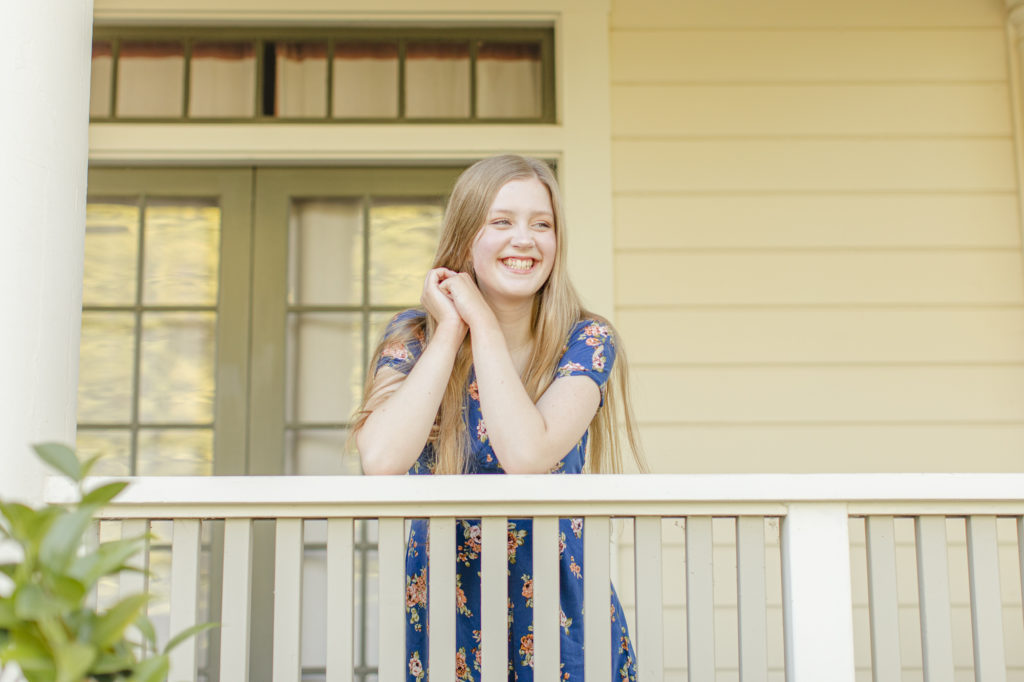 Girl posing on a porch