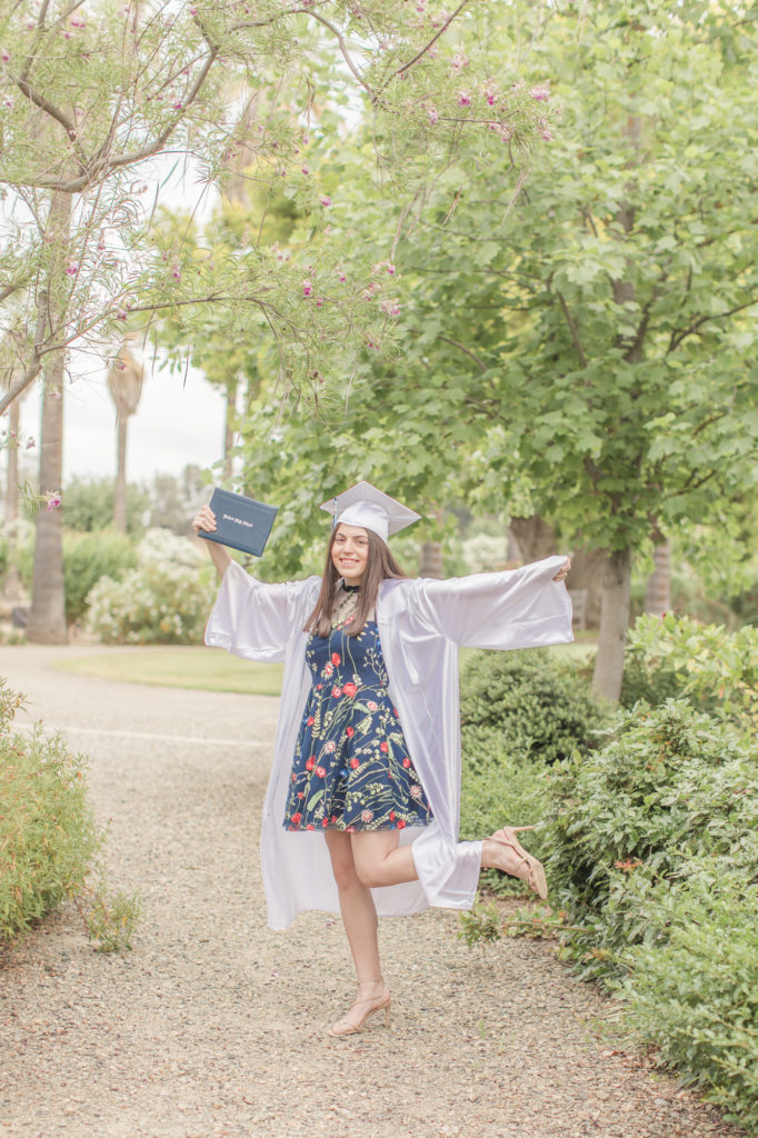 girl posing in cap and gown