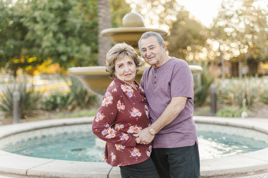 Harlan Ranch couple embracing in front of a fountain
