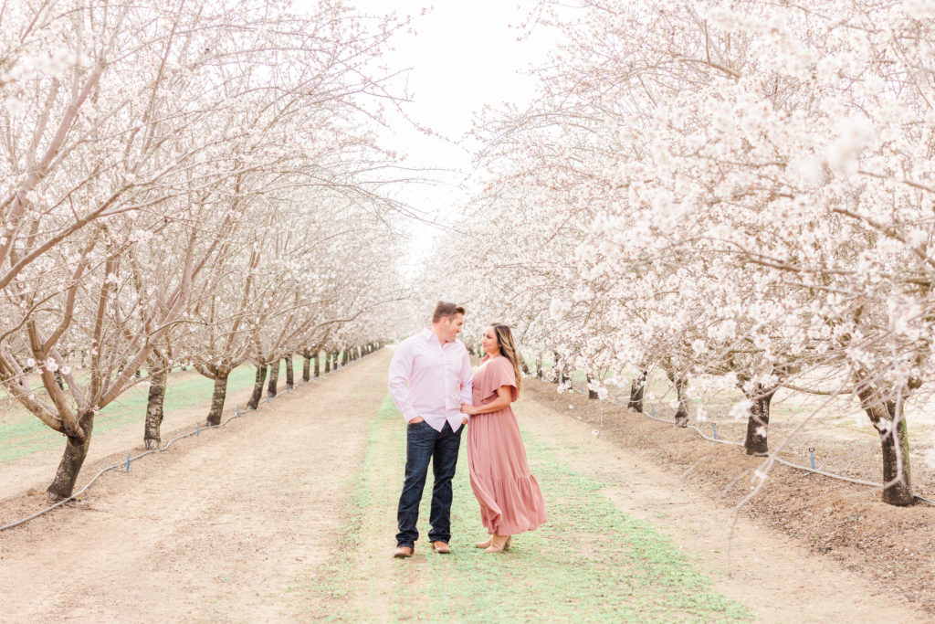 Couple in blossom trees on the blossom trail