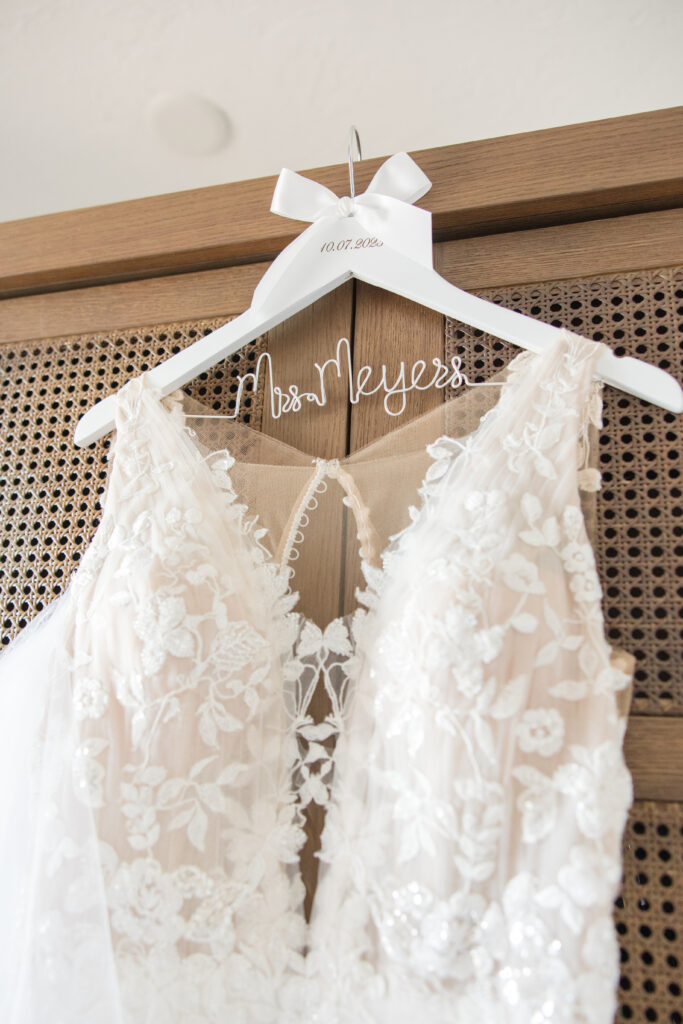wedding dress hanging on bridal hanger
