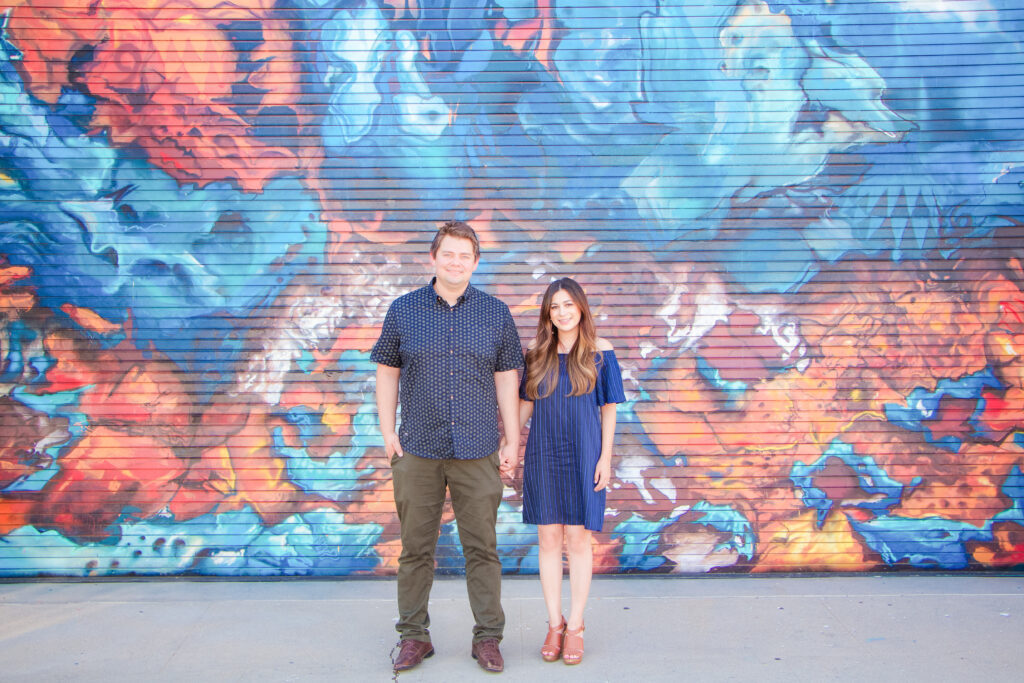 Couple standing in front of a mural