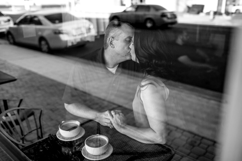 Couple kissing in a coffee shop